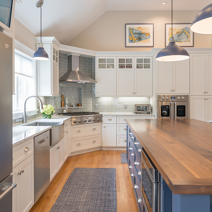 Modern farmhouse kitchen with blue island, hardwood floors, and industrial pendant lights