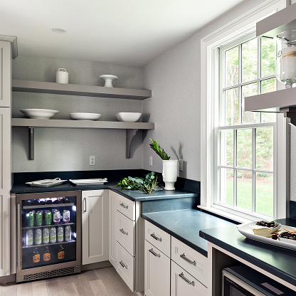 Modern butler's pantry with beverage fridge, white cabinets and floating shelves