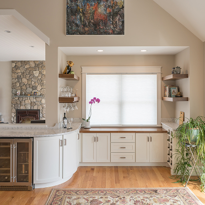Modern wet bar with stone fireplace, floating shelves and curved counter