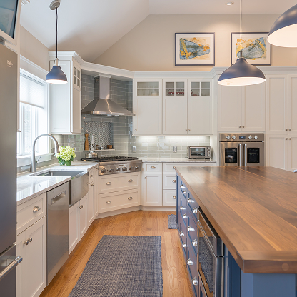 Transitional kitchen with blue island, butcher block countertop and glass-front cabinets
