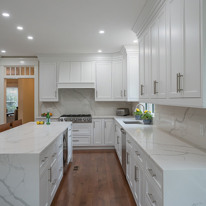 Luxury white kitchen remodel with marble countertops, hardwood floors and custom cabinetry - modern L-shaped design