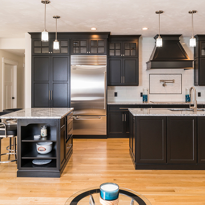 Black kitchen cabinets with stainless appliances, granite counters and hardwood floors - contemporary kitchen remodel