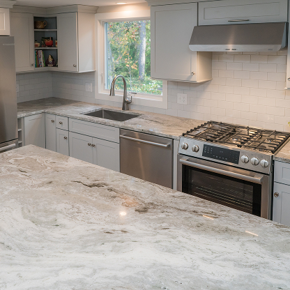 Modern kitchen with fantasy brown marble countertops, gray cabinets and stainless appliances - luxury renovation