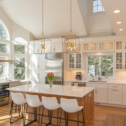 Luxury modern white kitchen with vaulted ceiling, geometric pendant lights, marble island, and white bar stools