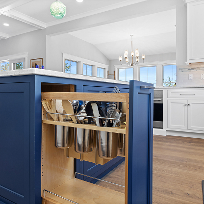 Custom kitchen utensil organizer pull-out in navy blue island cabinet