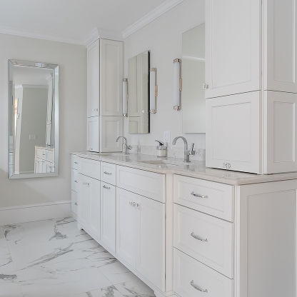 White bathroom vanity with marble floors and countertops, chrome fixtures