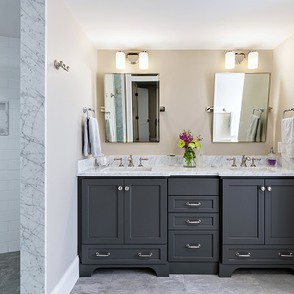 Charcoal gray bathroom vanity with marble countertop and chrome fixtures